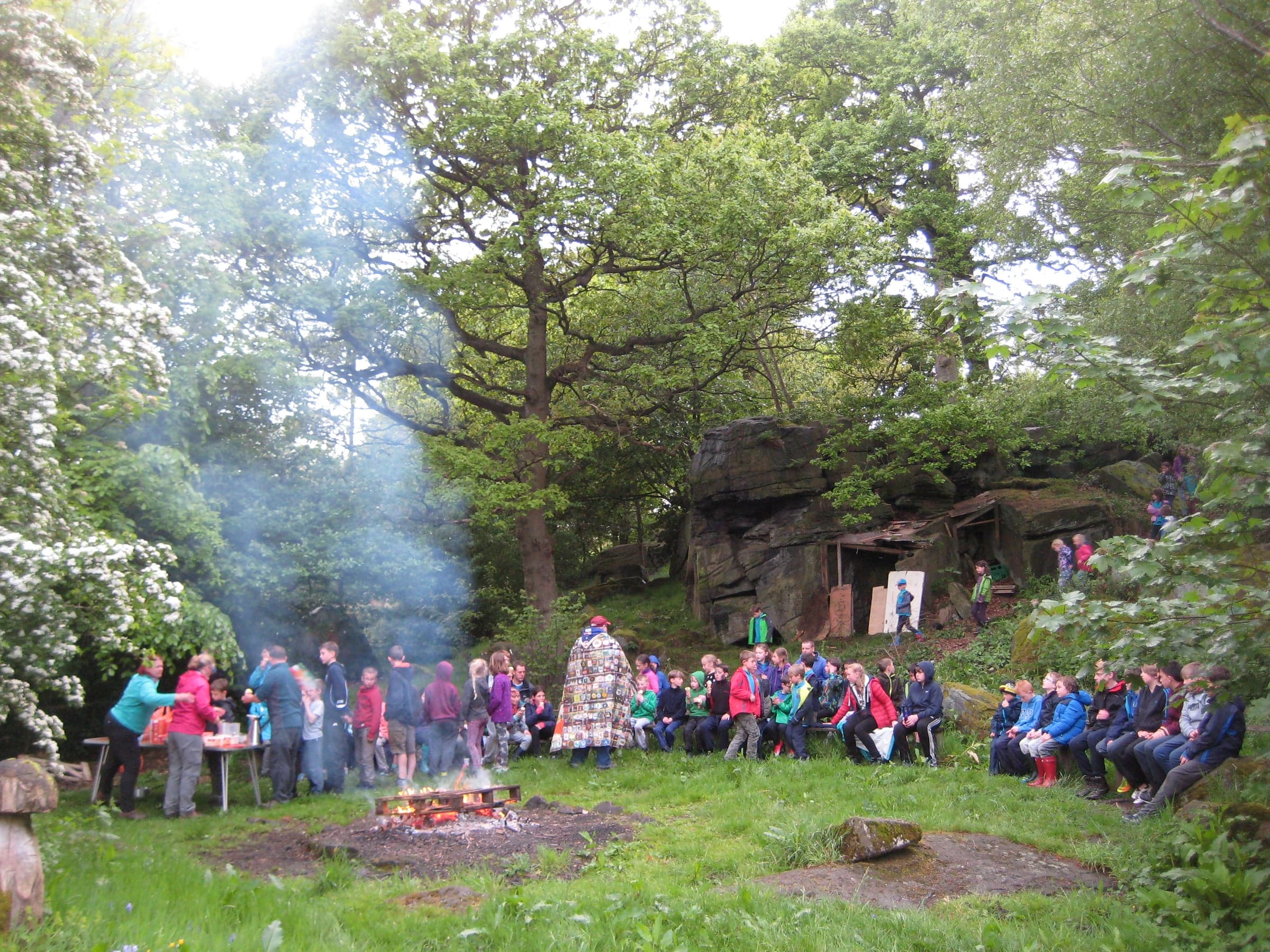 Gathered round the campfire in the woods.